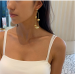 Small and large golden ball tassel earrings with a cool and elegant style. Long style earrings with personalized earrings